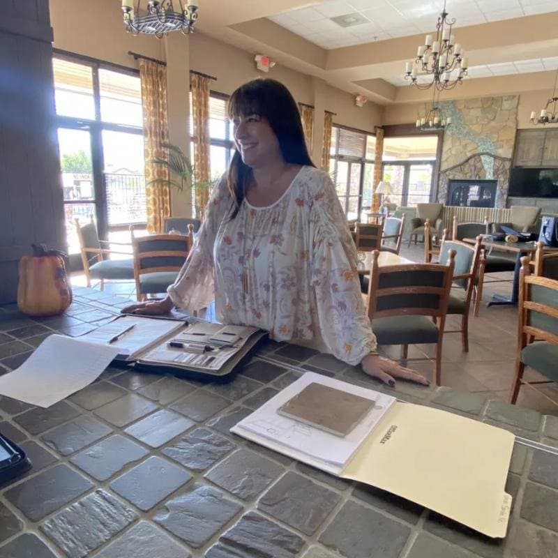 Dana Cavanaugh, Founder of Sedona Style and professional Sedona Interior Designer, reviewing material samples for a biophilic design project.