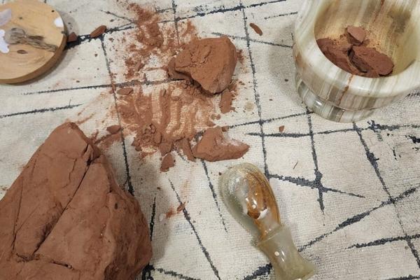 The process of preparing Sedona red earth for painting, a technique used by Sedona Interior Designer Dana Cavanaugh to incorporate biophilic design and natural textures into residential interiors.